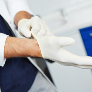 Dentist putting on gloves